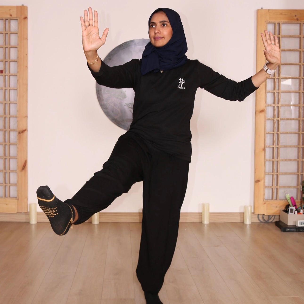 Tai Chi practice showing balance, slow controlled movement, and mind–body coordination at The Art of Qi in Riyadh.